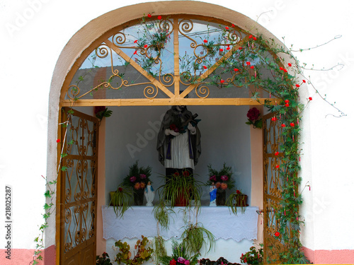 Holy statue in the window photo