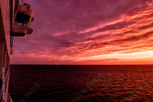 Cruise ship sailing into sunrise