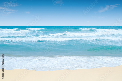 Strong wind and high wave in the sea and white sand beach with blue sky in summer for background.