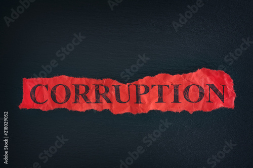 Torn piece of paper with the word Corruption