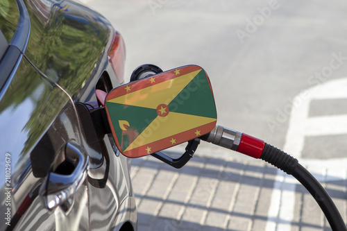Fueling car with petrol pump at a gas station.