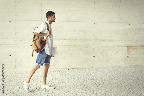 student with backpack and books walking with space for text
