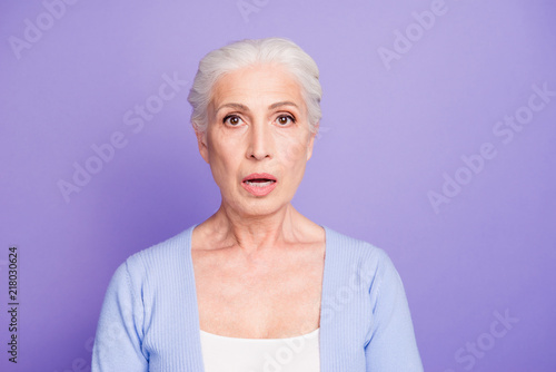 Portrait of grey haired old nice beautiful amazed shocked woman.