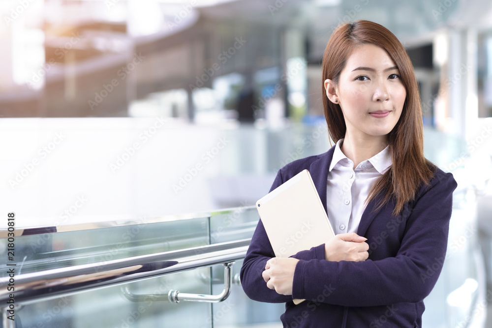 Business woman holding tablet in city with copy space Business woman holding tablet in city with copy space
