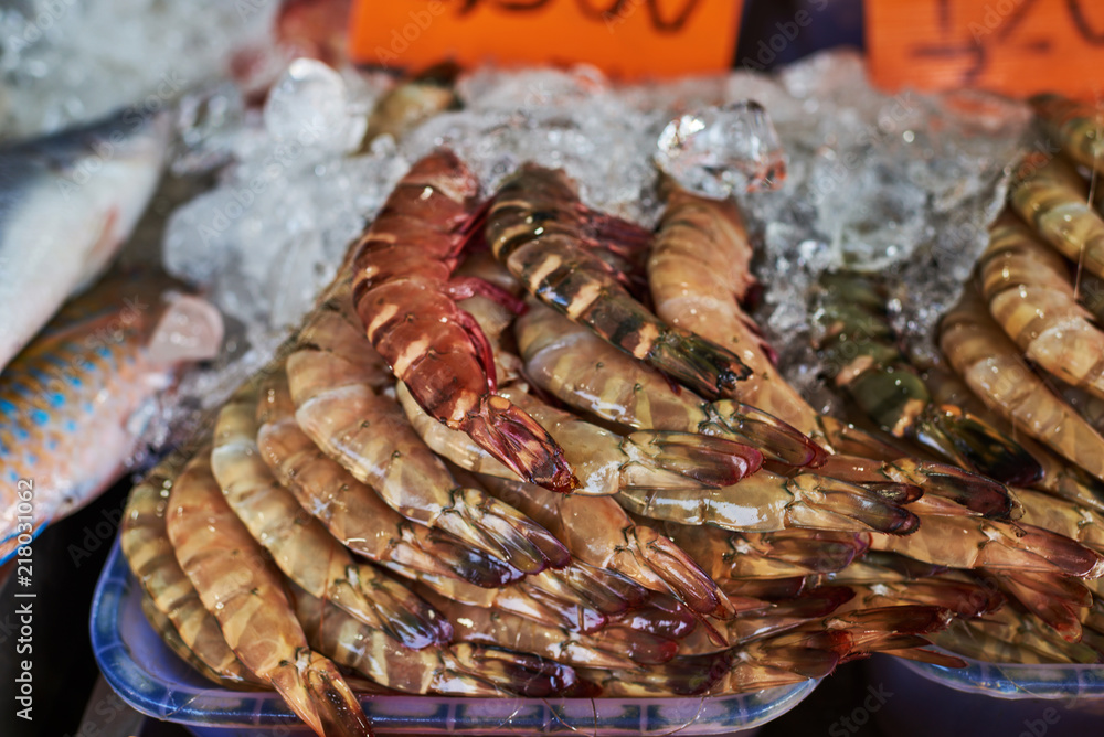 Display on the market with fish and large raw shrimps. Display on the market with fish and large raw shrimps.
