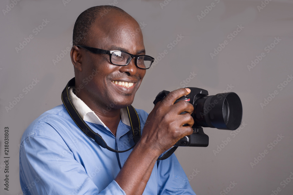 close-up of an adult african man and camera. close-up of an adult african man and camera.