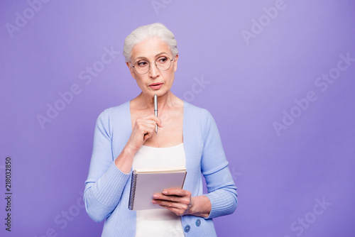 Gray haired old serious business woman wearing glasses  thinking