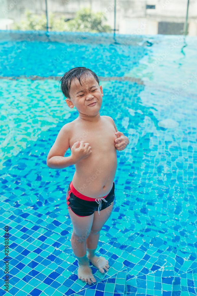 Stress Asian boy scratching his body on pool background. Summer concept