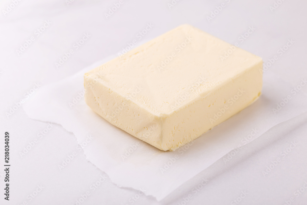 Stick of butter. Cutting board, dairy products