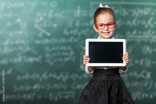 Little girl with digital tablet on background