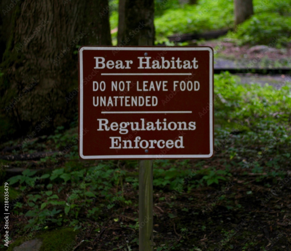 A close view on the brown park sign in the forest.