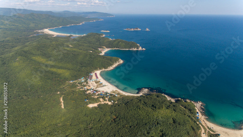 Drone aerial view from above on beautiful blue water bay on sunny day © Евгений Бахчев