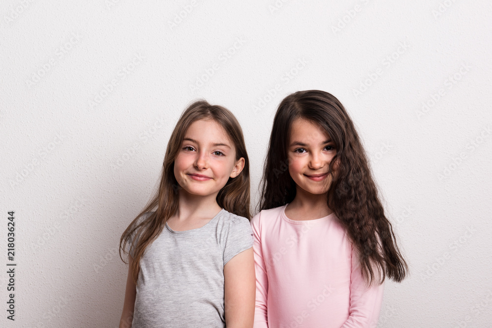 Two small girls standing in a studio. Two small girls standing in a studio.