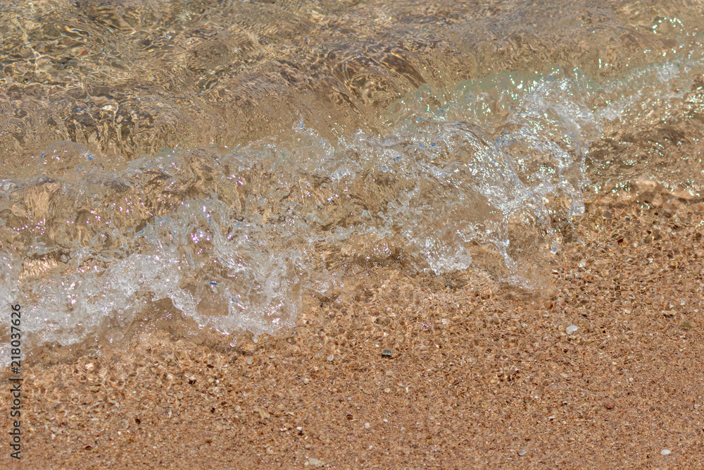 The sea wave runs on the sand