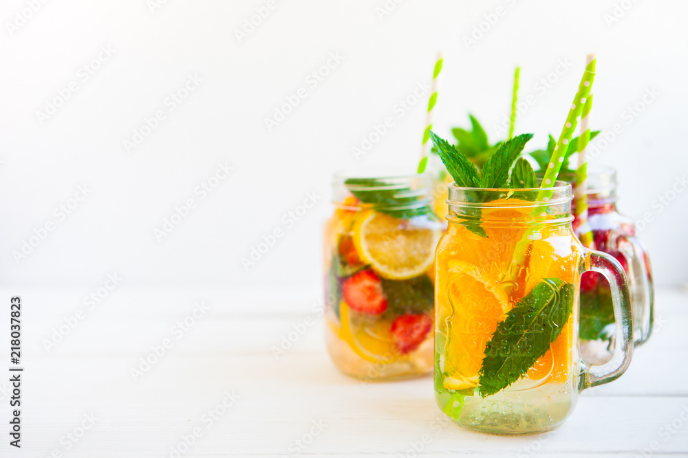 Fototapeta premium Homemade iced lemonade with mint, summer fruits and berries in a mason jar. Copy space background
