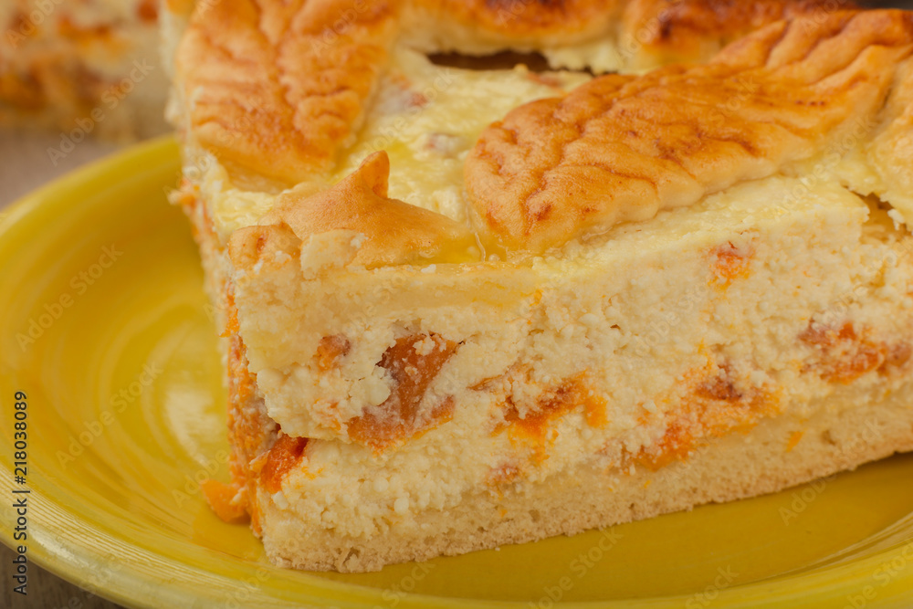 Cut homemade curd cake on a wooden background with ingredients. Cut homemade curd cake on a wooden background with ingredients.
