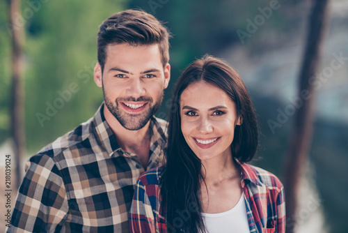 Portrait of nice lovely couple, spouses wearing casual checkered