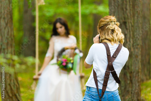 Professional wedding photographer taking close-up portraits of the bride