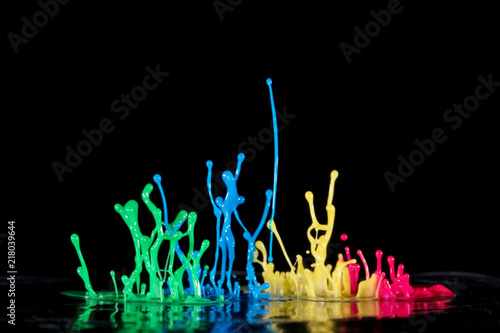 Abstract sculptures of colorful splashes of paint. Dancing liquid on a black background. Ink water splash. Color explosion.
