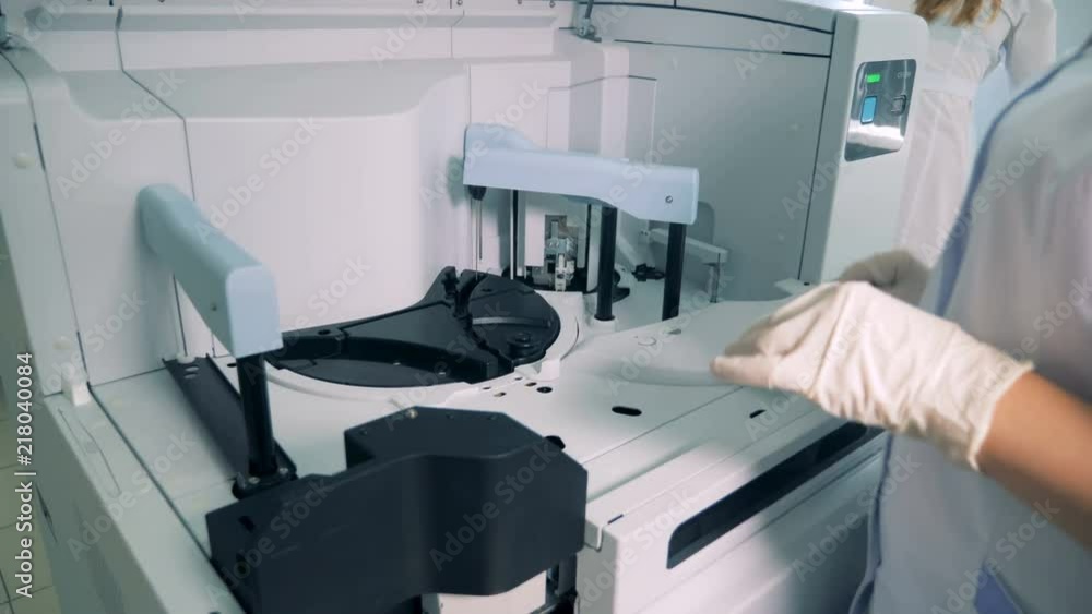 Vials with samples are getting put inside of an analyzing machine Vials with samples are getting put inside of an analyzing machine