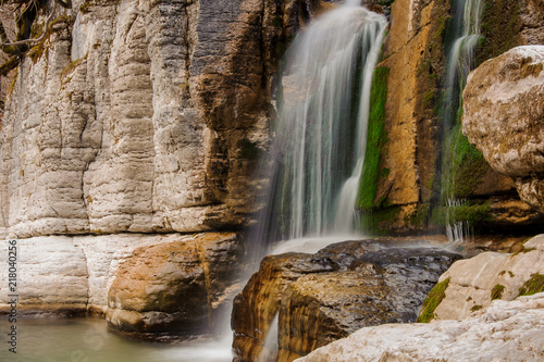 Georgous huge waterfall on the mountain river among the rocks