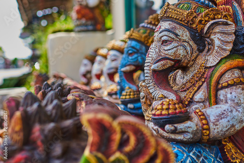 Typical souvenir shop selling souvenirs and handicrafts of Bali at the famous Ubud Market, Indonesia. Balinese market. Souvenirs of wood and crafts of local residents. Wooden statues made from wood. photo