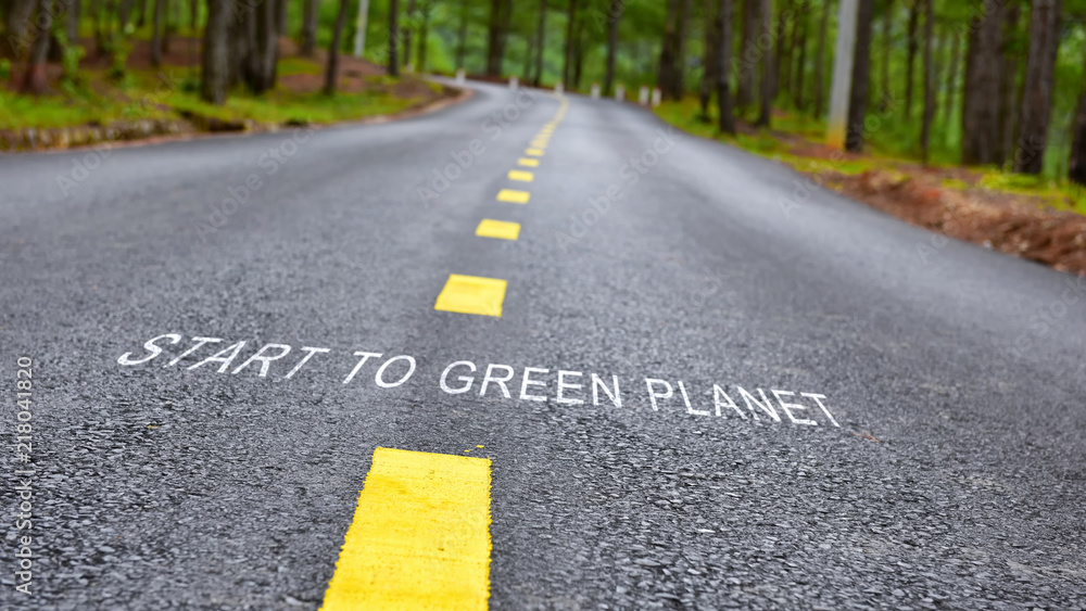 Start to green planet words on road surface, nature concept and save the earth idea