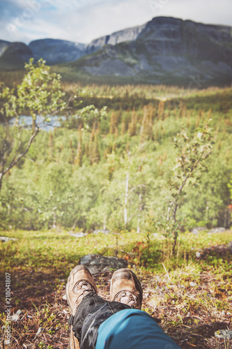 Legs of traveler hiker with beautiful nature view. Tourism concept