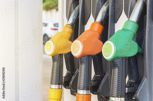 Three colored fuel pumps hooked to the gasoline dispenser