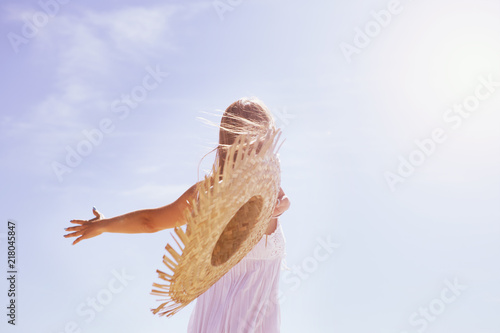Woman throws sun hat