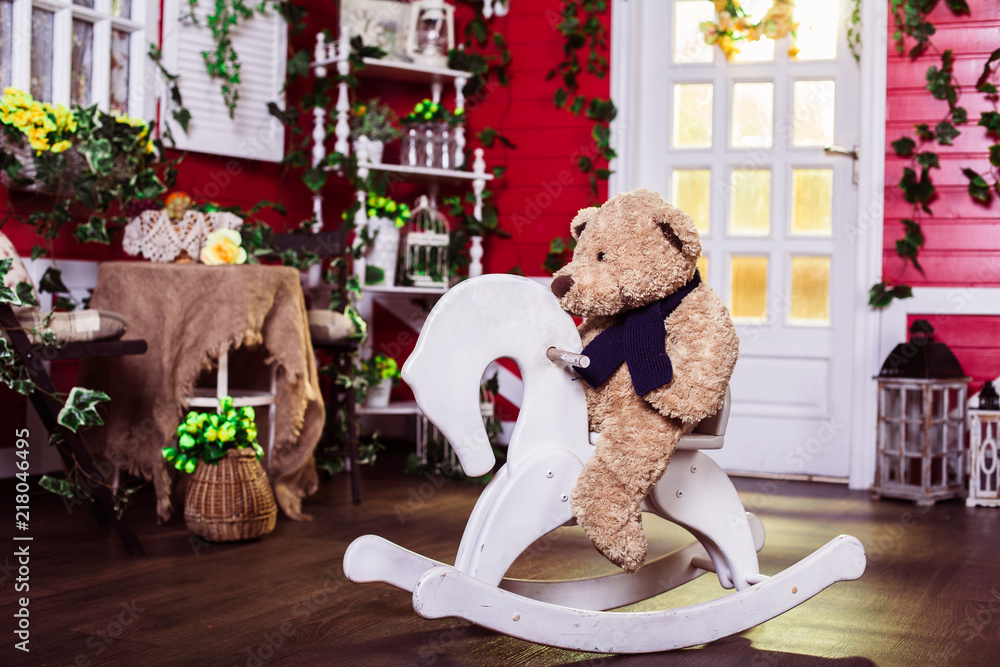 teddy bear rides a rocking horse Stock Photo | Adobe Stock