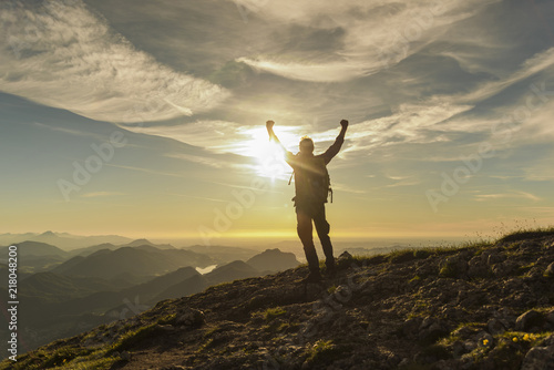 Austria, Salzkammergut, Hiker reaching summit, raising arms, cheering
