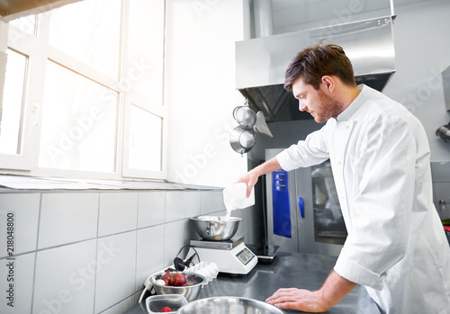 Картината върху платно cooking food, baking and people concept - happy male chef cook with eggs pouring