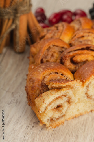 Pie with cinnamon and sugar on a wooden background.