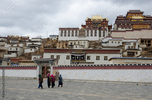 People walk outside Songzanlin Lama Tibetan Temple photo