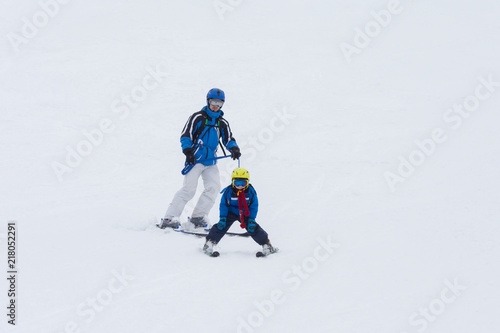 Young child, skiing on snow slope in ski resort in Austria