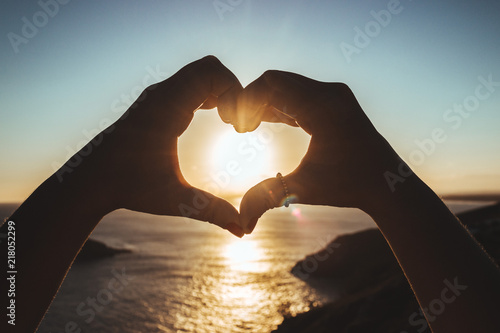 heart in hand sunset