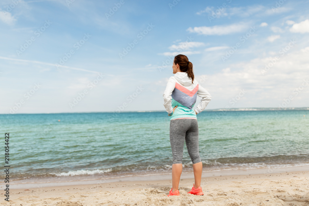 fitness, sport and healthy lifestyle concept - woman in sports clothes on beach fitness, sport and healthy lifestyle concept - woman in sports clothes on beach
