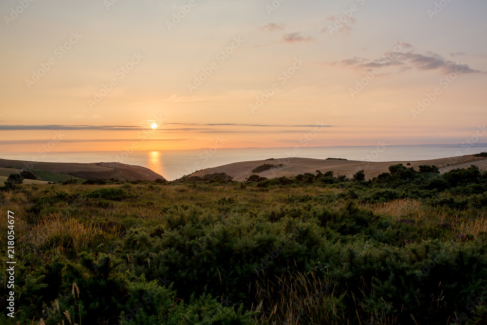Sunset over the ocean from the beautiful nature of Exmoor