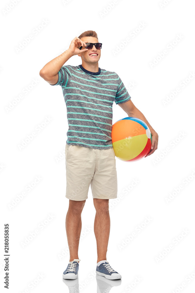 leisure, summer holidays and people concept - smiling young man in sunglasses with beach ball over white background leisure, summer holidays and people concept - smiling young man in sunglasses with beach ball over white background