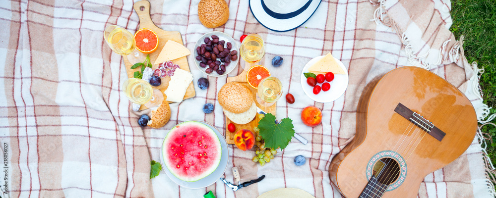 Summer Picnic Basket on the Green Grass. Food and drink concept. Friends Party time Summer Picnic Basket on the Green Grass. Food and drink concept. Friends Party time