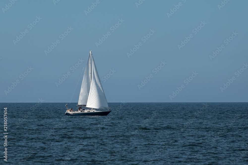 Blue Sailboat at Sea