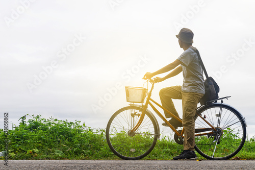 Man riding a bicycle in countryside.
