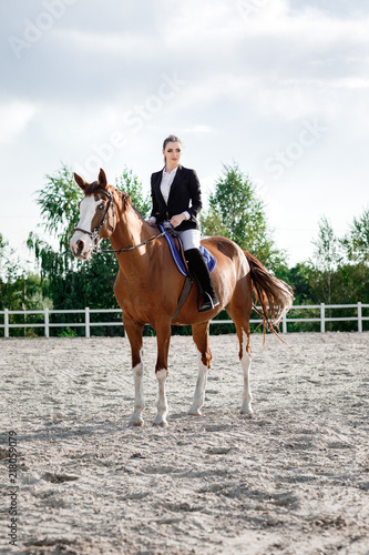 Rider elegant woman riding her horse outside © producer