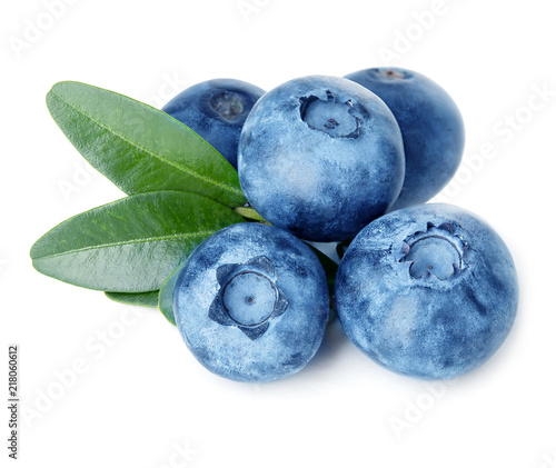 Blueberries with green leaves isolated on white background.