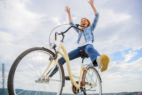 Freedom and delight. Woman feels free while enjoy cycling. Most satisfying form of self transportation. Cycling gives you feeling of freedom and independence. Girl rides bicycle sky background