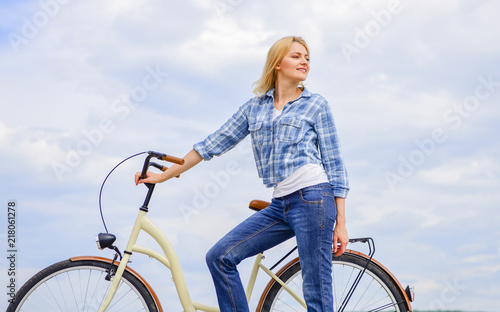 Active leisure and healthy activity. Girl ride cruiser model bicycle. Woman rides bicycle sky background. Healthiest most environmentally friendly and most satisfying forms of self transportation