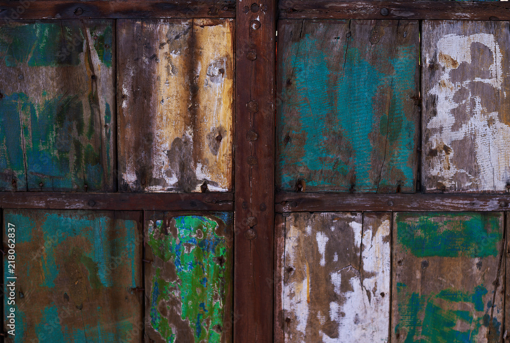 Abstract grunge wood texture background. Patterned and textures background of brightly colored panels of weathered painted wooden boards. Vintage wooden wall with peeling  paint.