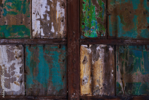 Abstract grunge wood texture background. Patterned and textures background of brightly colored panels of weathered painted wooden boards. Vintage wooden wall with peeling paint.