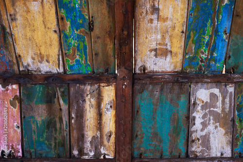Abstract grunge wood texture background. Patterned and textures background of brightly colored panels of weathered painted wooden boards. Vintage wooden wall with peeling paint.